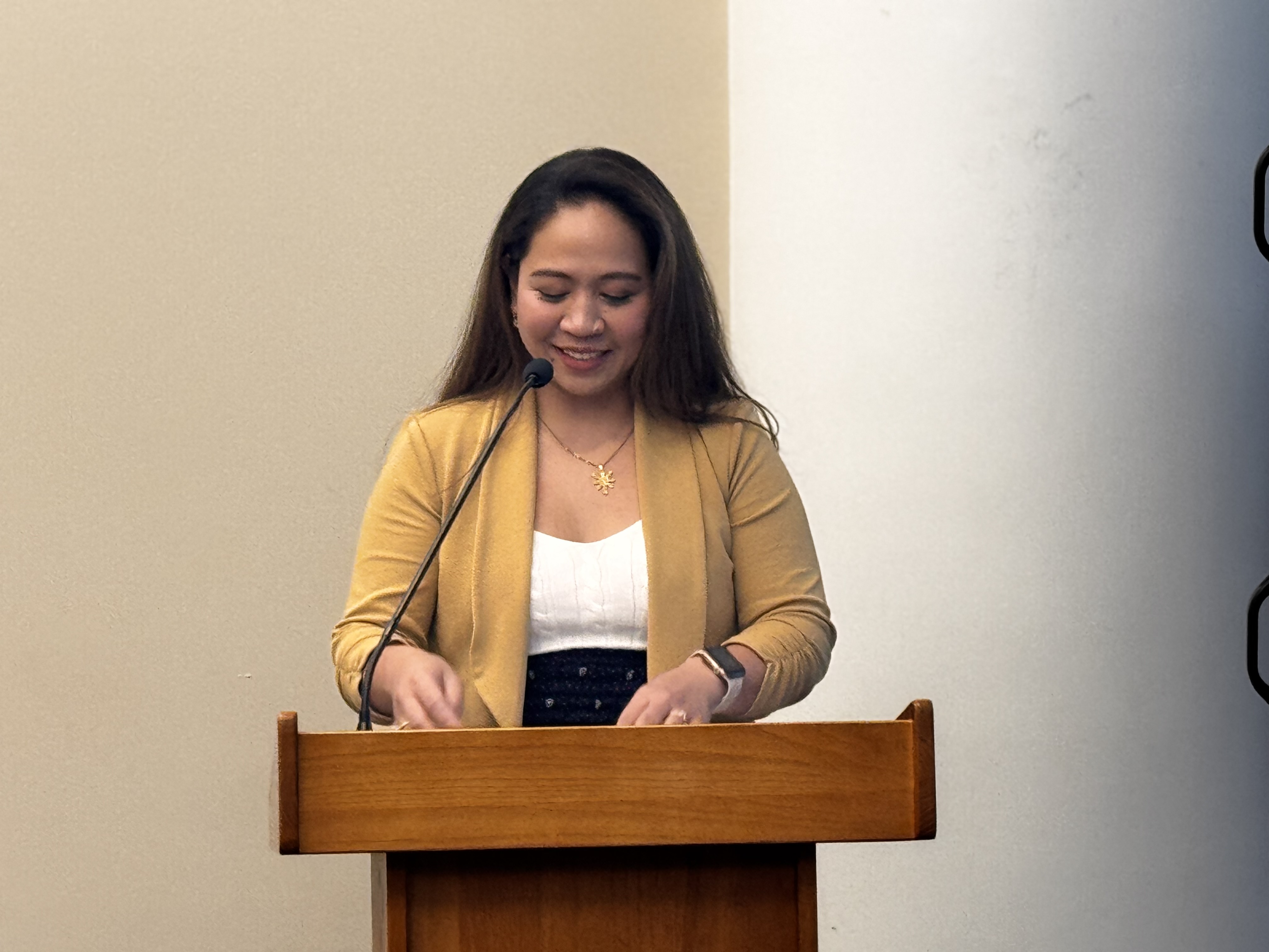 Speaker sharing her story at the podium during Ọgbaniko