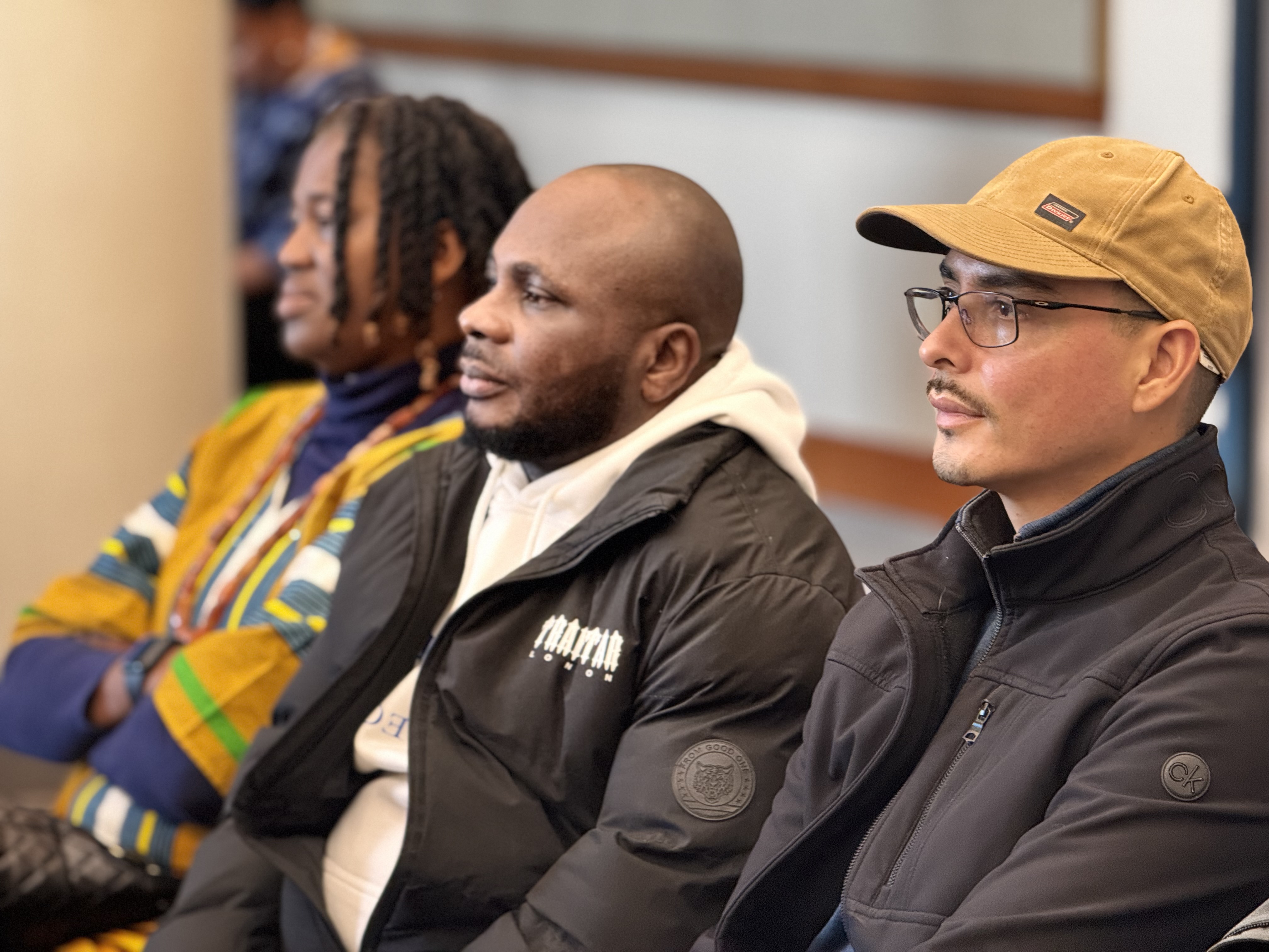 Community members listening intently at Ọgbaniko